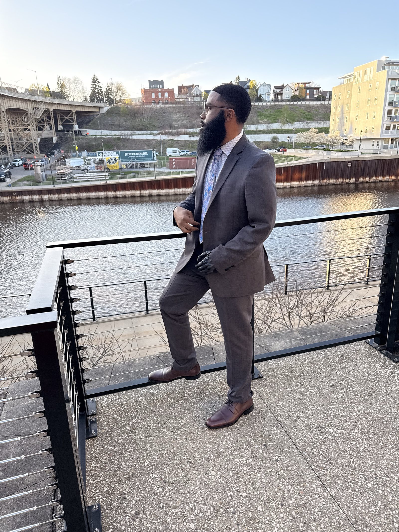 Jonathan Freeman in a gray suit by the Milwaukee River